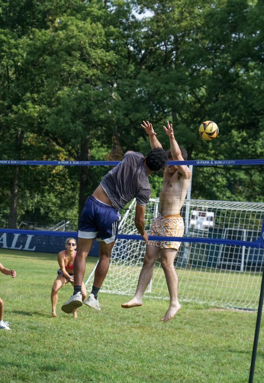 College Grass Open grass volleyball action